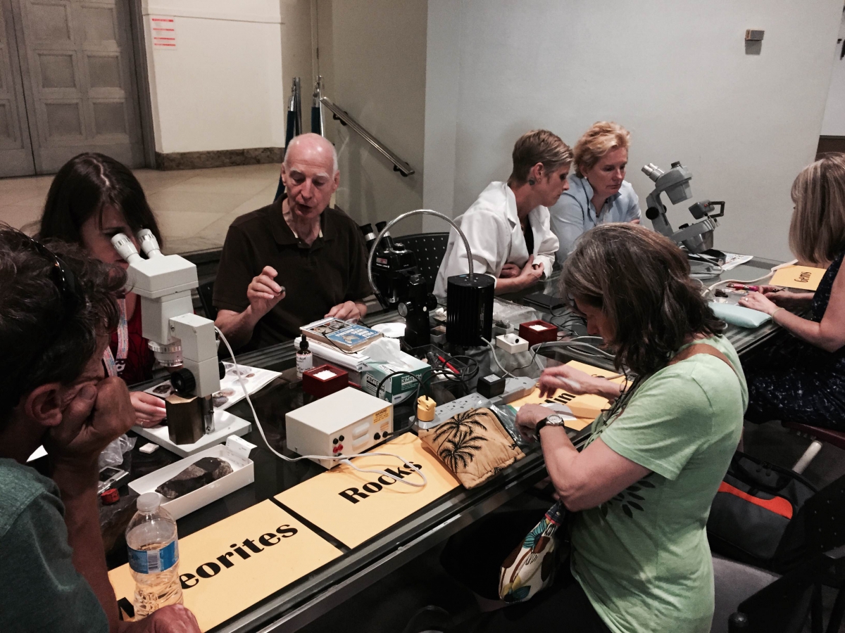 ROM staff at a table identifying visitors' treasures. 