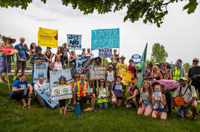 People holding signs protesting against Nestlé.