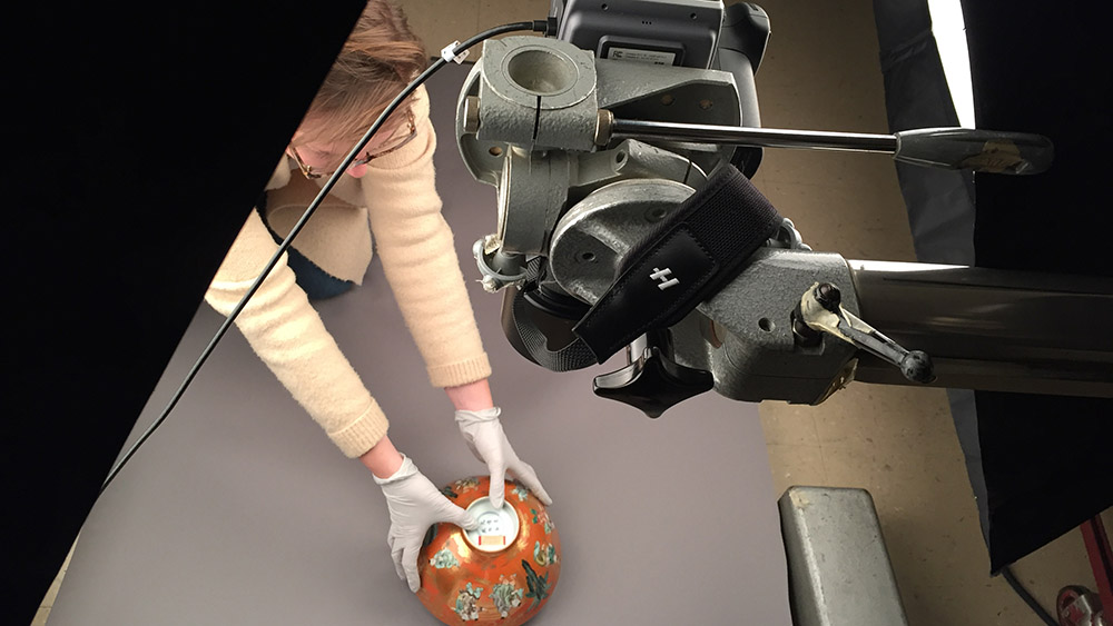 Technician prepares vase for digitization.