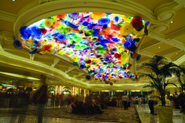 Ceiling of a resort that has colourful glass flowers on it