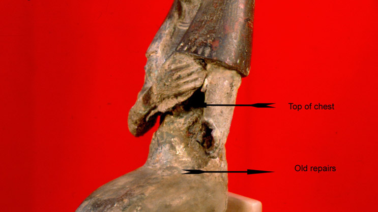 Detail of lifted chest Image of the torso showing old repairs to the artifact.