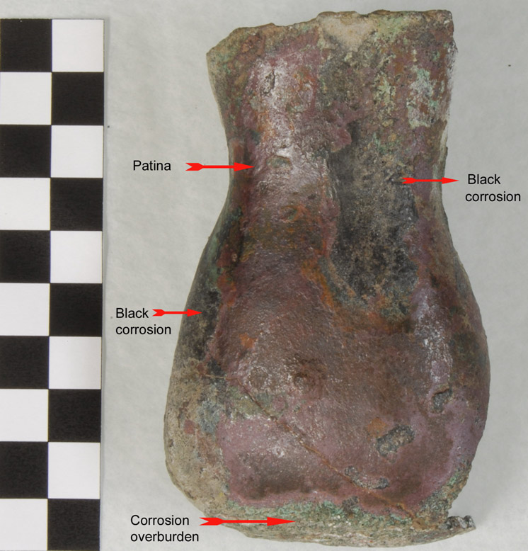 Back of torso showing unusual black corrosion; patina; corrosion overburden (photo: F. Schlicht) The torso of the figurine once the head and legs were removed during conservation.
