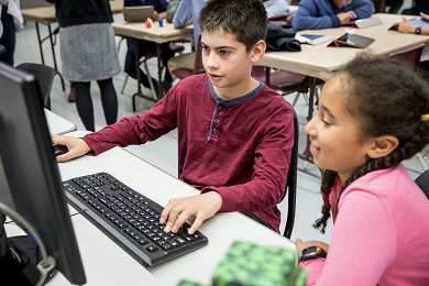 two children use a computer in the ROM Makerspace