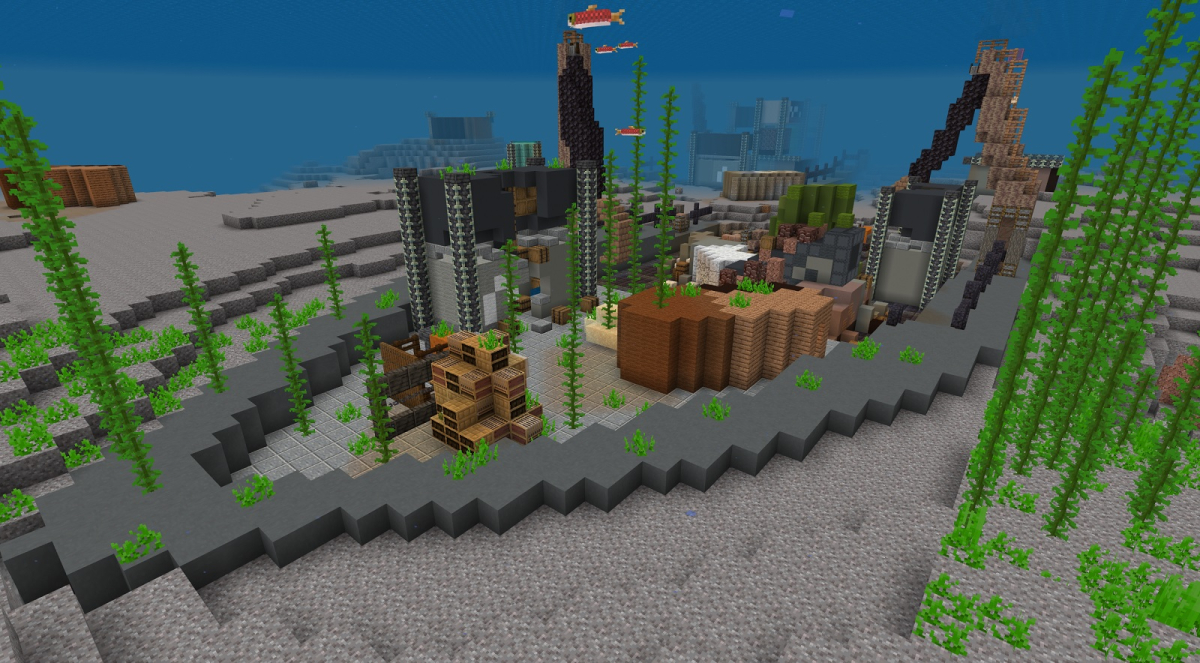 A Minecraft screenshot of a sunken cargo ship with fish swimming around crane arms and broken cargo containers