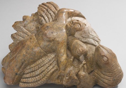 a statue of a woman lying on the back of a turtle