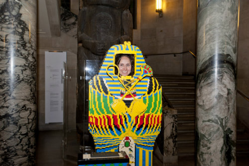 We also have an upright LEGO sarcophagus that you can take your picture in. Isn’t this just the new wallpaper image you’ve been looking for? Overview of a lego mummy, with a woman peaking her head through.