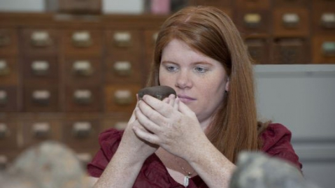 Visitor holding a meteorite at the ROM