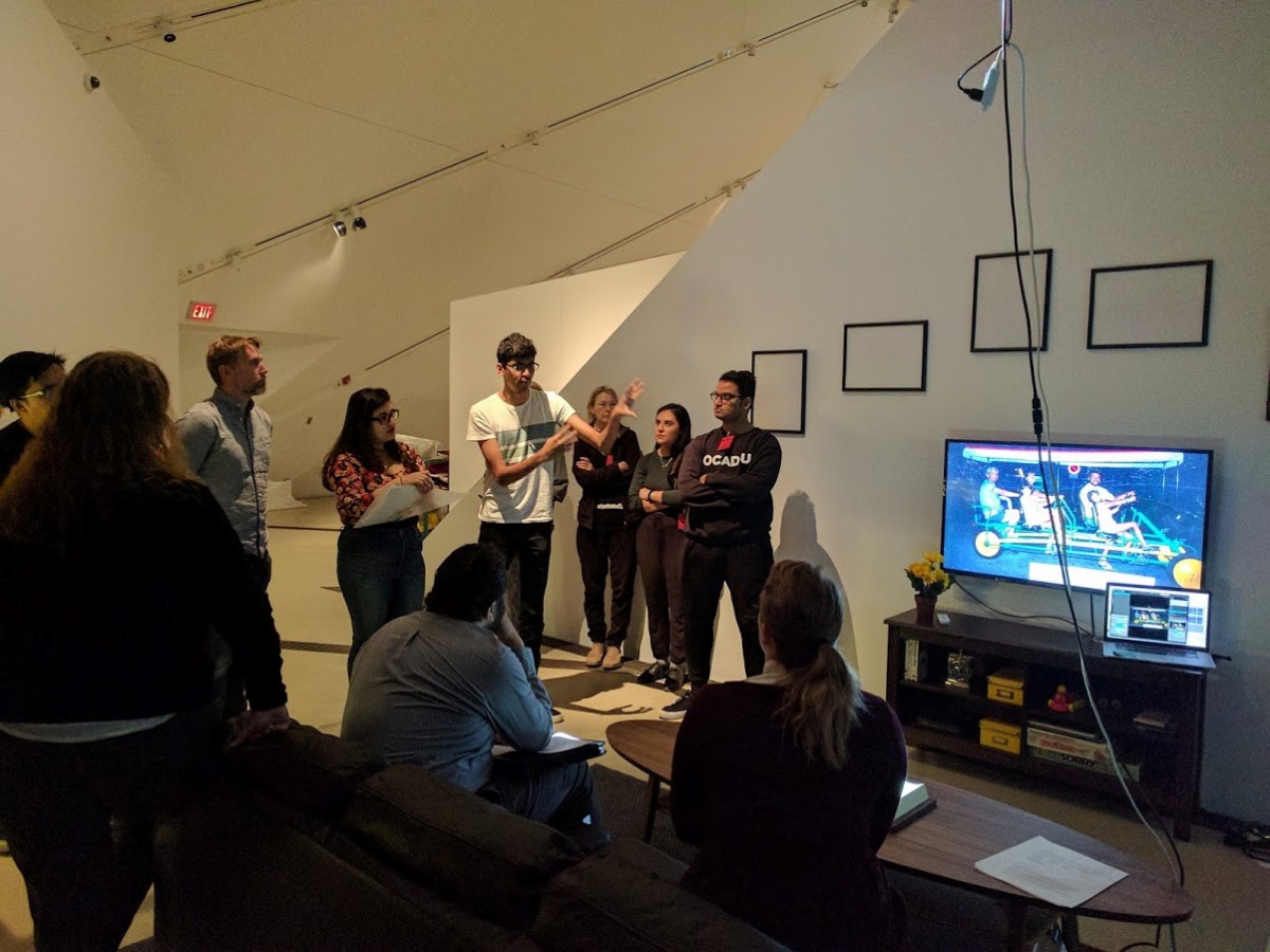 students discussing their work with ROM staff in the Roloff Beny gallery at ROM