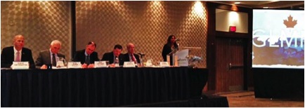 Photo of Dilhari Fernando, Invasive Species Centre Executive Director, moderating the event in Toronto, along with a long table featuring many other panel speakers 