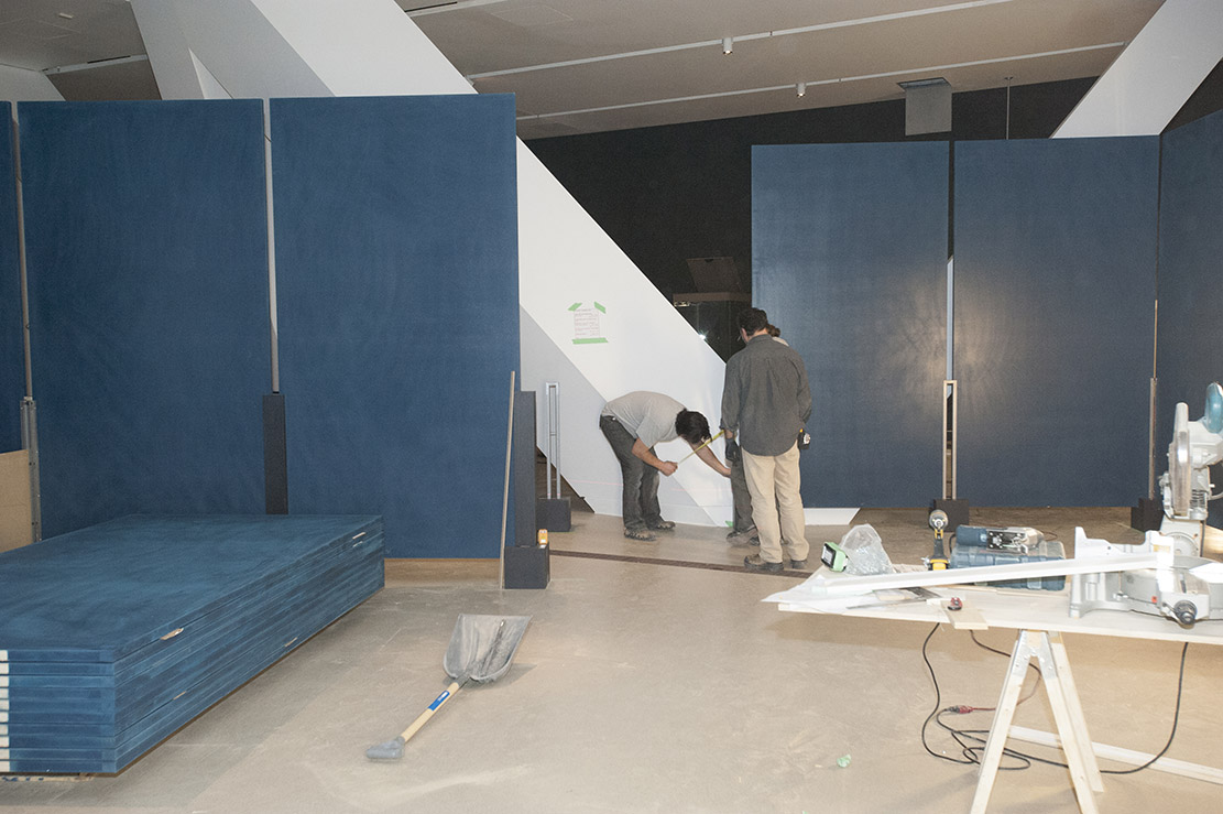 Installing Forbidden City Exhibition at the ROM, Men looking at walls