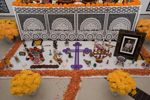 Close up of the lowest tier of the ofrenda with Sergio’s magnificent paper crucifix as centrepiece.