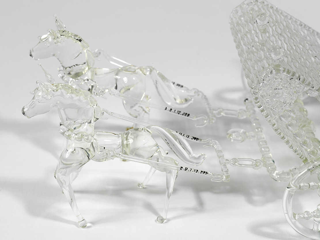 detail of model glass coach showing horses and harnass