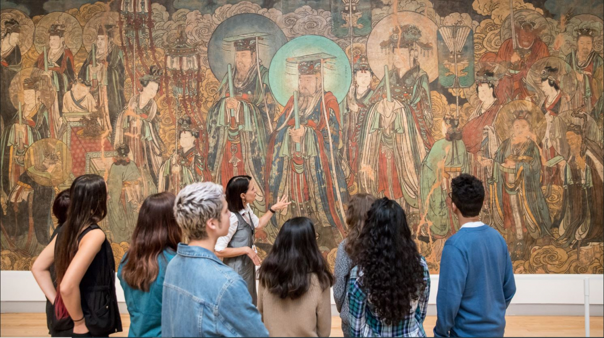 A group of visitors enjoy a guided tour of the galleries.