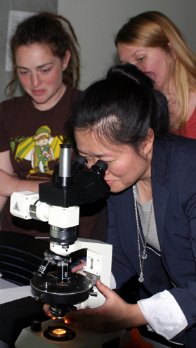 Teaching students to use a polarizing light microscope - photo by David Brantley