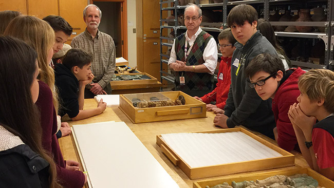 Bill Pratt meets with the students in his work area, the West Asian & Egyptian Collections rooms. 