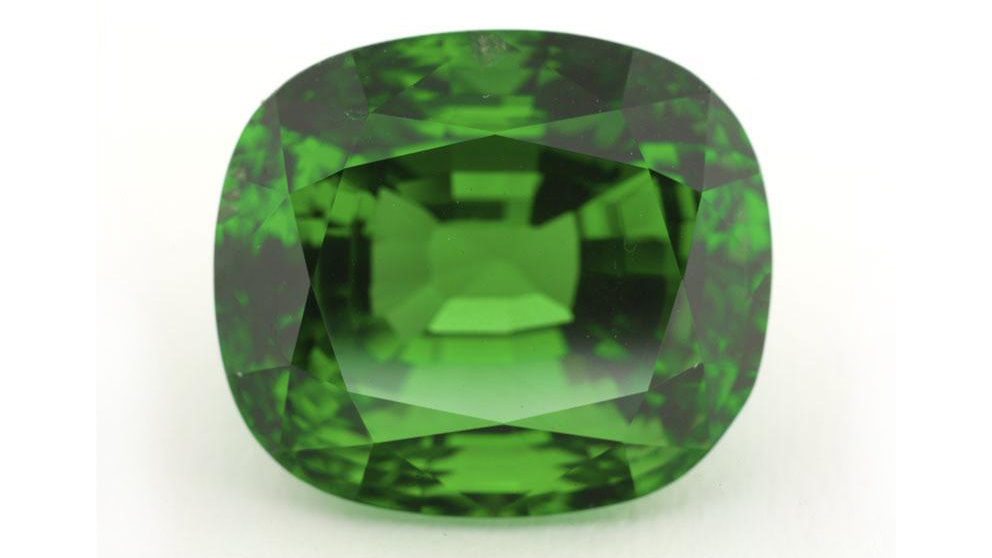 Faceted green gemstone.