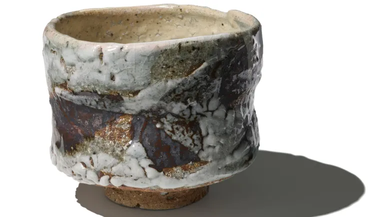 Image of a textured, glazed tea bowl by Japanese potter Ōmine Jissei