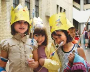 3 children with crowns enjoying birthday party celebrated at ROM