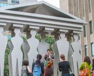 Group of people on a ROMWalks Plus tour led by a guide.
