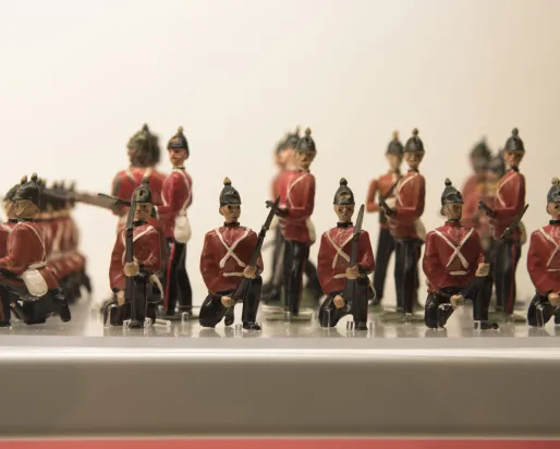 Close-up of a group of toy soldiers in red jackets standing in formation