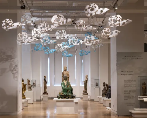 Paper clouds floating above Chinese statues