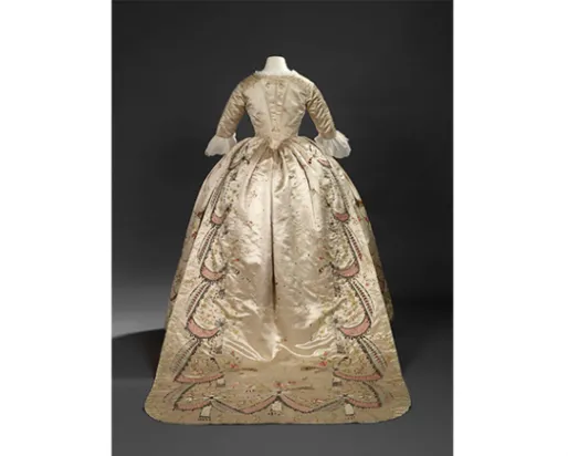 Overdress of a robe en fourreau. Attributed to Marie-Jean "Rose" Bertin (French couturière, 1747-1813). France. 1780's, altered in 1870's. Embroidered satin with ribbon appliqués, sequins, faceted glass stones mounted on silver facings, and silver filé; fitted, boned bodice. 925.18.3.A.