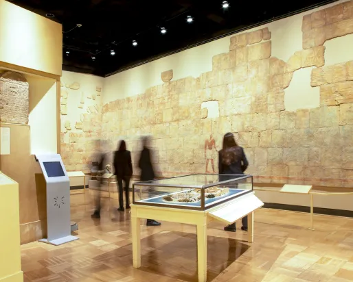 Galleries of Africa: Egypt People look at the wall of the of the gallery which features a rebuilt painted Egyptian wall.