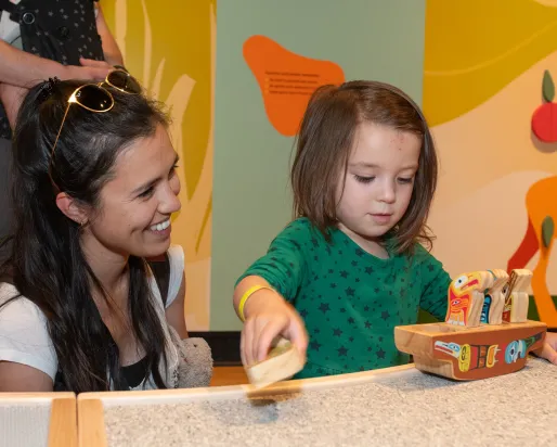 Child enjoying ROM Kids Junior program with parent watching