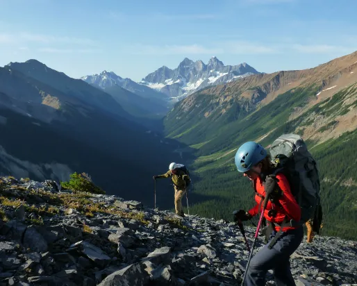 2 hikers going up a mountain search for fossils