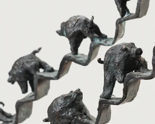 Sculpture of pigs walking up and down a staircase 