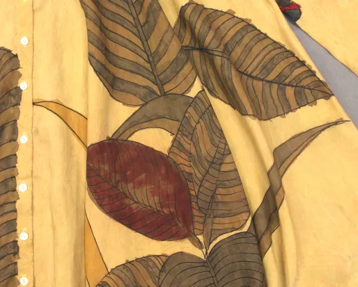 Leaves stitched on to a yellow blanket.