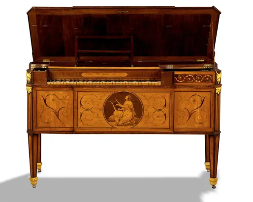 An ornate, antique wooden piano with decorative inlays, gold accents, and an image of a seated woman playing a lyre on the front panel, displayed against a white background.