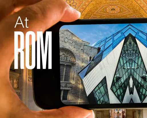 A hand holds up a phone displaying an image of the Royal Ontario Museum mirrored down the middle. Text reads at ROM.