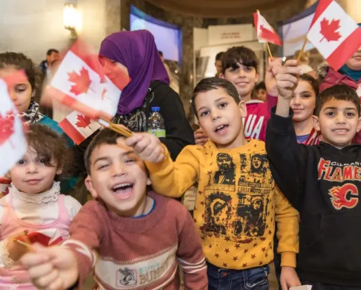 Kids waving Canadian flags
