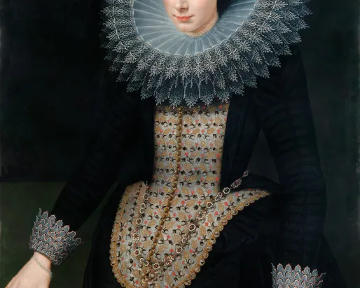 Portrait of a woman in a black dress with a large white lace "ruff" collar, on a black background.