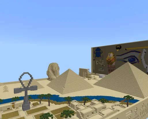 A minecraft screenshot showing a desert crossed by a blue river, pyramids, a giant ankh, and other Egyptian elements