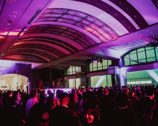 A DJ performing for a crowd at Royal Ontario Museum in the Currelly Gallery.