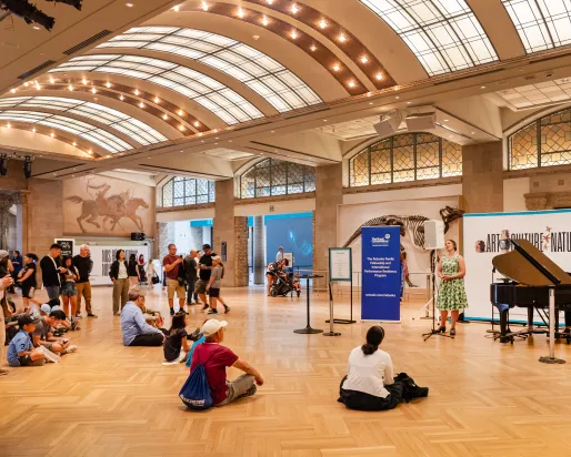 Gathering around a performance on the main floor at the Royal Ontario Museum. 