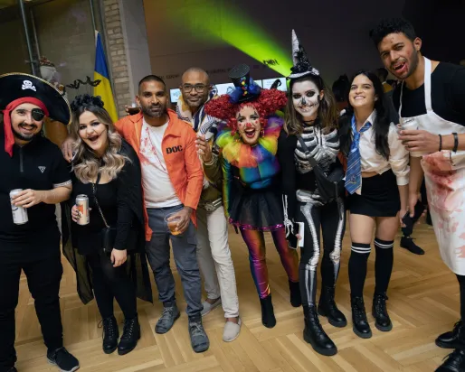 A group of people in Halloween costumes in the museum.