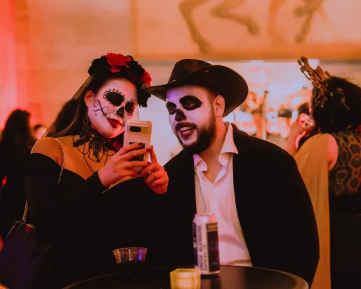 A woman and a man dressed up for Day of the Dead celebrations.