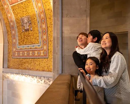 A family looking up at ROM's ceiling.