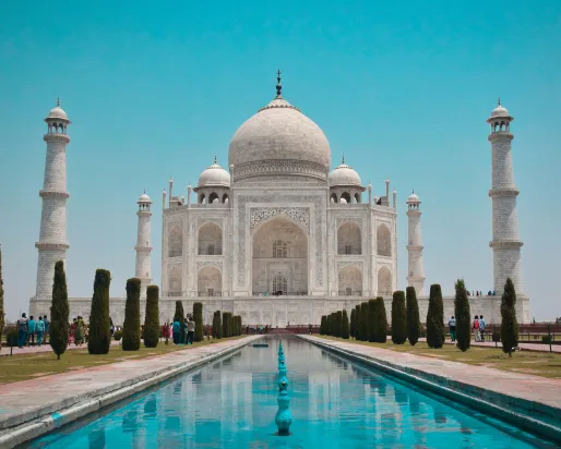 A white building with a dome and four towers