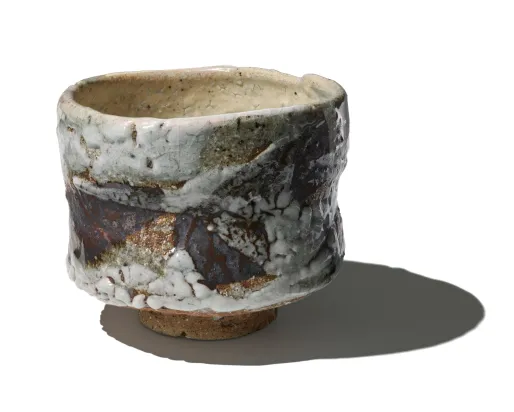 Image of a textured, glazed tea bowl by Japanese potter Ōmine Jissei