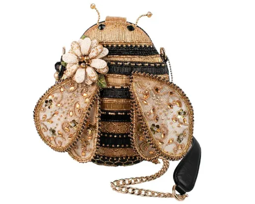 Gold and black beaded and embellished shaped loosely like a bumble bee.