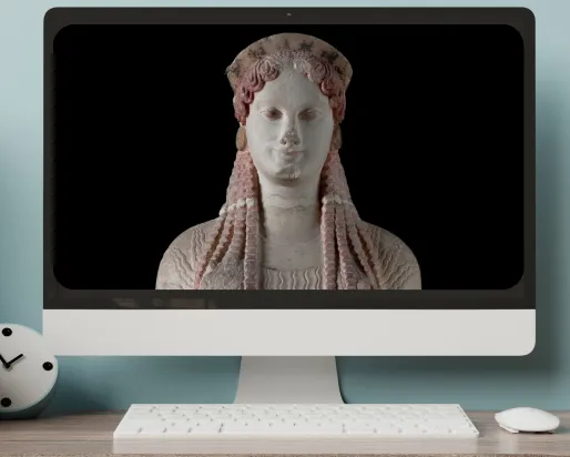 a monitor on a desktop displays an image of a greek statue