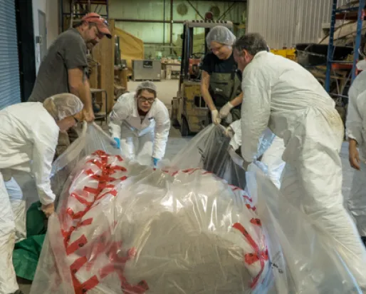 It took a team of seven people to lift the blue whale heart enough to finish wrapping it. Photo by Stacey Lee Kerr

