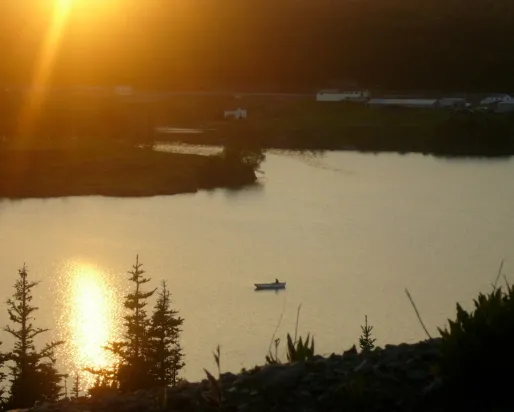 bateau de pêche dans un port au coucher du soleil
