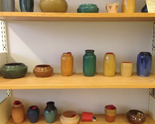 Detail of ceramic vessels on shelf
