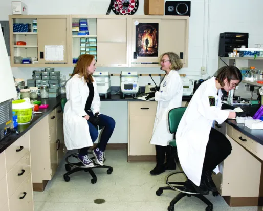 Three women in a lab running DNA testing
