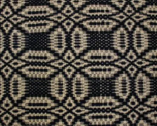 Detail of black and white woven coverlet.
